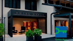a hotel ivka with chairs and plants in front of a building at Hotel Hvala Superior - Topli Val in Kobarid