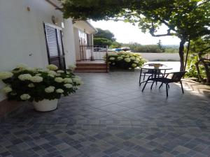 a patio with a table and chairs and flowers at Studio Apartment Sekula in Šibenik