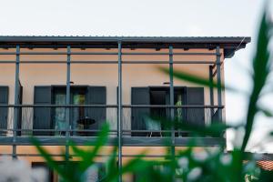a building with a balcony with a dog on it at Hotel Hvala Superior - Topli Val in Kobarid