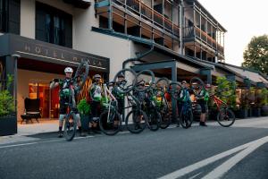 a group of people on bikes in front of a building at Hotel Hvala Superior - Topli Val in Kobarid