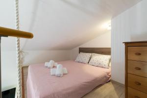 a bedroom with a bed with white towels on it at Villa Alexandra 3 in Pješčana Uvala 