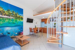 a living room with a fish mural on the wall at Villa Alexandra 3 in Pješčana Uvala 