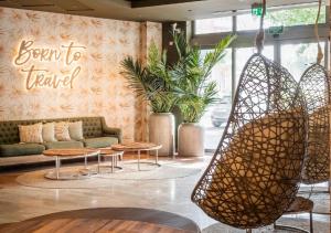 a lobby with tables and a sign that reads born to travel at Hotel SB Express Tarragona in Tarragona