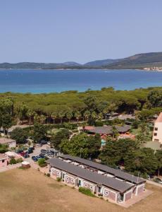 an aerial view of a parking lot and a lake at La Meta Sporting Rooms in Alghero