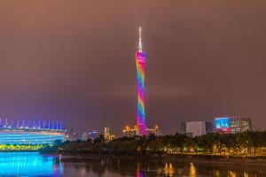 a tall tower lit up in rainbow colors at night at Orange Tree International Hotel Zhujiang New Town US Consulate General Guangzhou Branch - Free Shuttle Bus to Canton Fair Complex During Canton Fair Period in Guangzhou