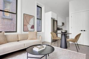 a living room with a couch and a table at UWS 1BR w Elevator WD nr Central Park NYC-857 in New York