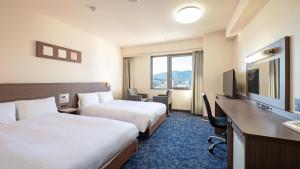 سرير أو أسرّة في غرفة في EN HOTEL Ise
