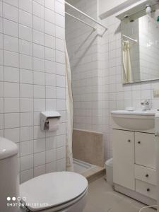 a white bathroom with a toilet and a sink at Boa Vista Playa As Sinas en Vilanova de Arousa in Villanueva de Arosa