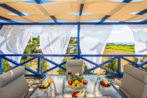 a glass table with fruit on top of a tent at Villa Alba Minies in Minia