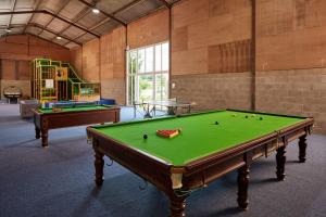 a large room with a pool table and a playground at Woodpecker Way at Eaton Manor in Eaton