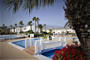 a white bridge over a pool in a resort at Casa Bonita, Golf del Sur in San Miguel de Abona