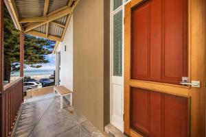 a door to a balcony with a view of the ocean at Rawsons shack Beachfront unit suits single or couple in Henley Beach South