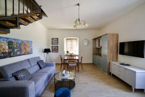 a living room with a blue couch and a table at New renovated appartment Mauri in Poreč