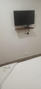 a flat screen tv sitting on top of a wall at RAAJ PEARL in Chennai