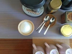 a table with a bowl of milk and spoons at Apartament Parterowy in Poznań