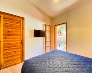 a bedroom with a bed and a tv on the wall at Panoramica casa al mare in Bosa