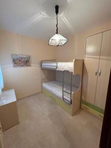 a room with two bunk beds and a light at Casa Tia Angelita in Aguilar de la Frontera