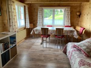 a dining room with a table and chairs in a cabin at Bauernhaus Cafrida in Flumserberg