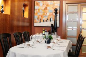 a table in a restaurant with a white table cloth at Hotel Hvala Superior - Topli Val in Kobarid