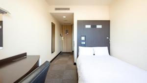 سرير أو أسرّة في غرفة في EN HOTEL Ise