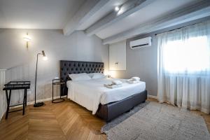 a bedroom with a large bed and a window at Hs4U Ricasoli Luxury apartment near Duomo N. 3 in Florence