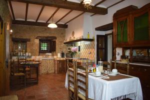 a kitchen with a table and chairs in a room at Apartamentos Casona de Linares in Selaya
