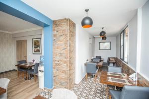 a room with a stone wall and tables and chairs at Konuk Hotel in Eskisehir