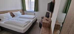 Postel nebo postele na pokoji v ubytování Hotel Ladage