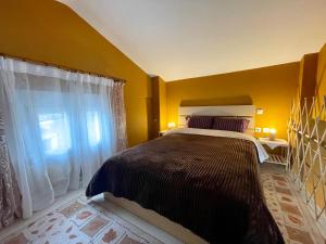 a bedroom with a large bed and a window at Hilltop Lodge Orma in Orma