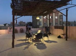a patio with a table and chairs on a roof at Key Of Life House in Luxor