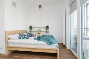 a bedroom with a bed with a wooden headboard at ShortStayPoland Kasprzaka (B113) in Warsaw