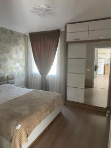 a bedroom with a bed and a dresser and a mirror at House in Mtskheta in Mtskheta