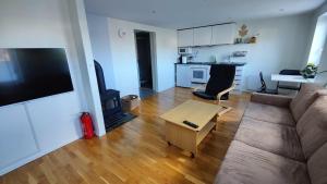 a living room with a couch and a table at Apartment Ulsteinvik in Ulsteinvik
