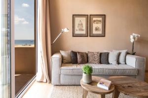 a living room with a couch and a table at The Margi in Athens