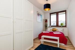 a bedroom with a bed with a red blanket at ShortStayPoland Grodkowska (B114) in Warsaw