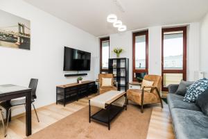 a living room with a couch and a table at ShortStayPoland Grodkowska (B114) in Warsaw +6 photos