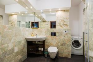 a bathroom with a sink and a washing machine at ShortStayPoland Grodkowska (B114) in Warsaw
