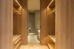 a bathroom with wooden cabinets and a toilet in a room at The Margi in Athens