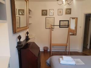 a room with a bed and a mirror and a dresser at Cozy Place in Oxford