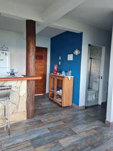 a kitchen with a counter and a blue wall at Village as casinhas in Uruçuca