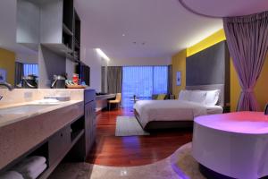 a hotel room with a bed and a bathroom at LiT BANGKOK Hotel - SHA Extra Plus in Bangkok