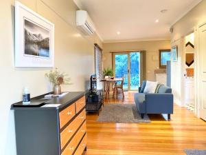 a kitchen and living room with a couch and a table at Brigadoon Cottages in Haunted Hills