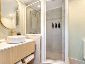 a bathroom with a sink and a shower at Mercure Cairns in Cairns