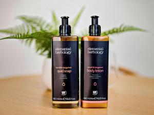 two bottles of shampoo sitting on a table at Mercure Cairns in Cairns