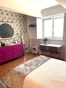 a bedroom with a bed and a desk and a sink at Apartament in Principe Real in Lisbon