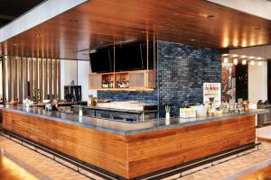 a bar in a restaurant with a counter at Hyatt Centric Downtown Denver in Denver