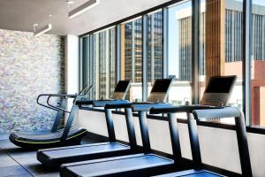 a gym with a row of cardio machines in a building at Hyatt Centric Downtown Denver in Denver