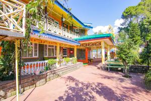 a building with a bench in front of it at Royal Green Buds in Pathyar