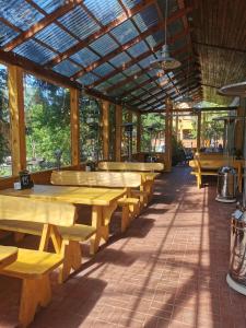 a row of wooden tables and benches in a restaurant at O.W. Sęk in Karwia