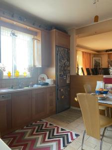 a kitchen with a table and a sink and a table and chairs at Πηνελόπη Apartment 3-bed flat in Tripolis